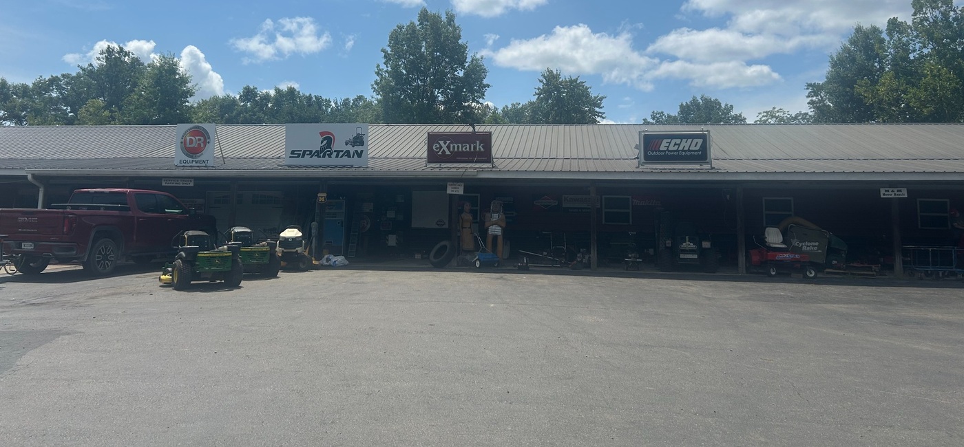 M&M Mower Repair shop front on State Road 59 with road sign visible