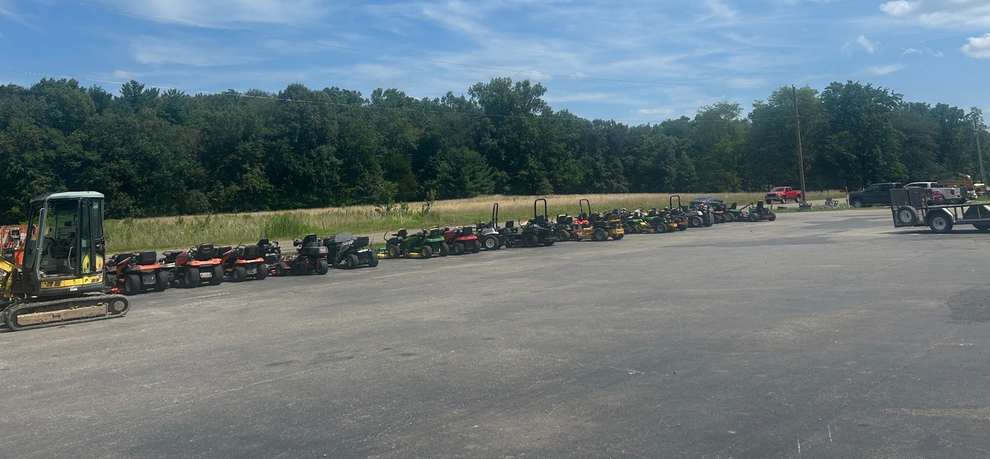 Equipment lot at M&M Mower Repair with units lined up